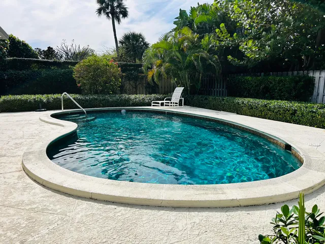 a view of a swimming pool with a yard