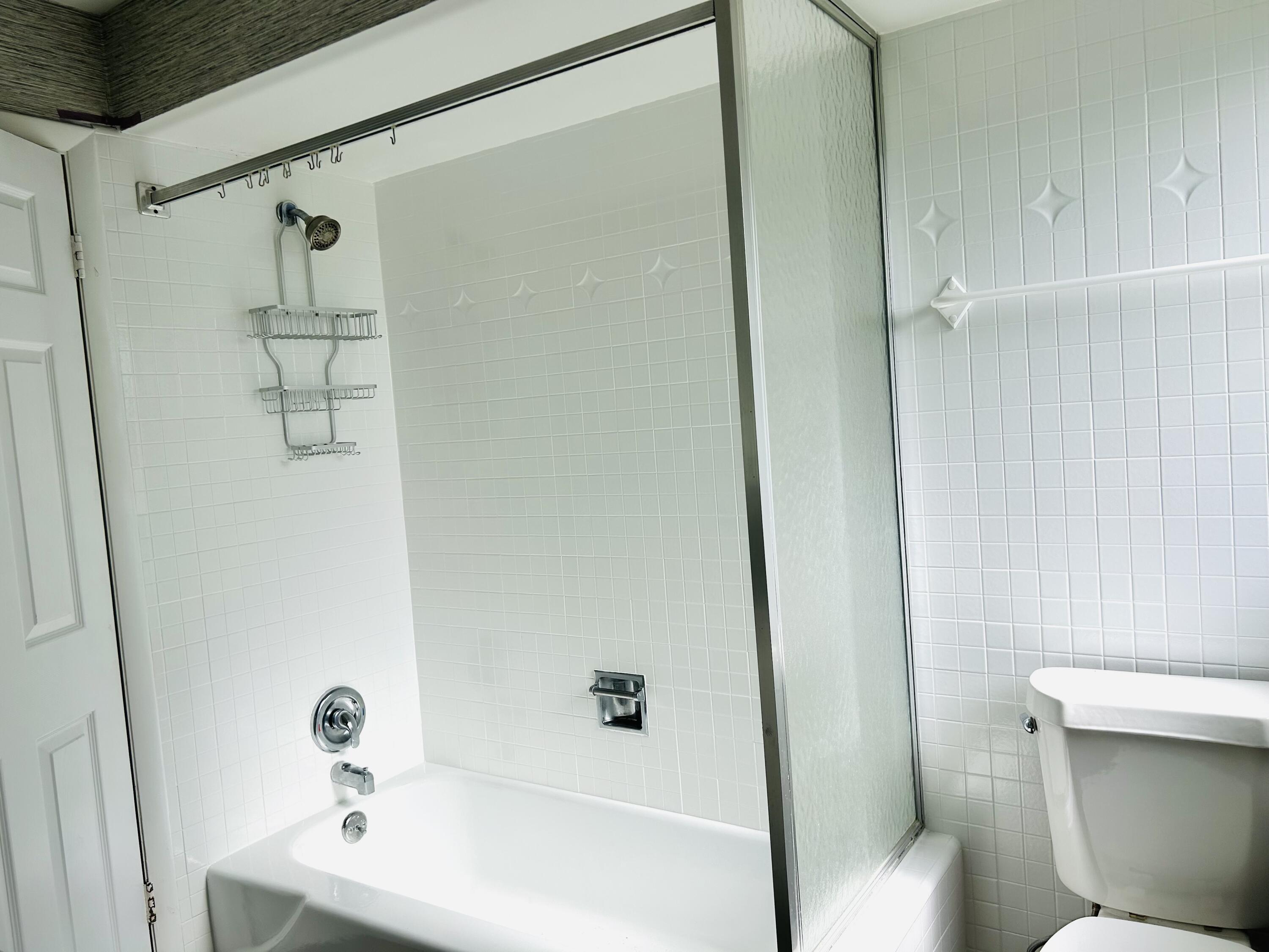 162 Beacon Lane Jupiter Inlet Colony, FL 33469 - Photo 8 of 16 a bathroom with a sink a toilet and shower