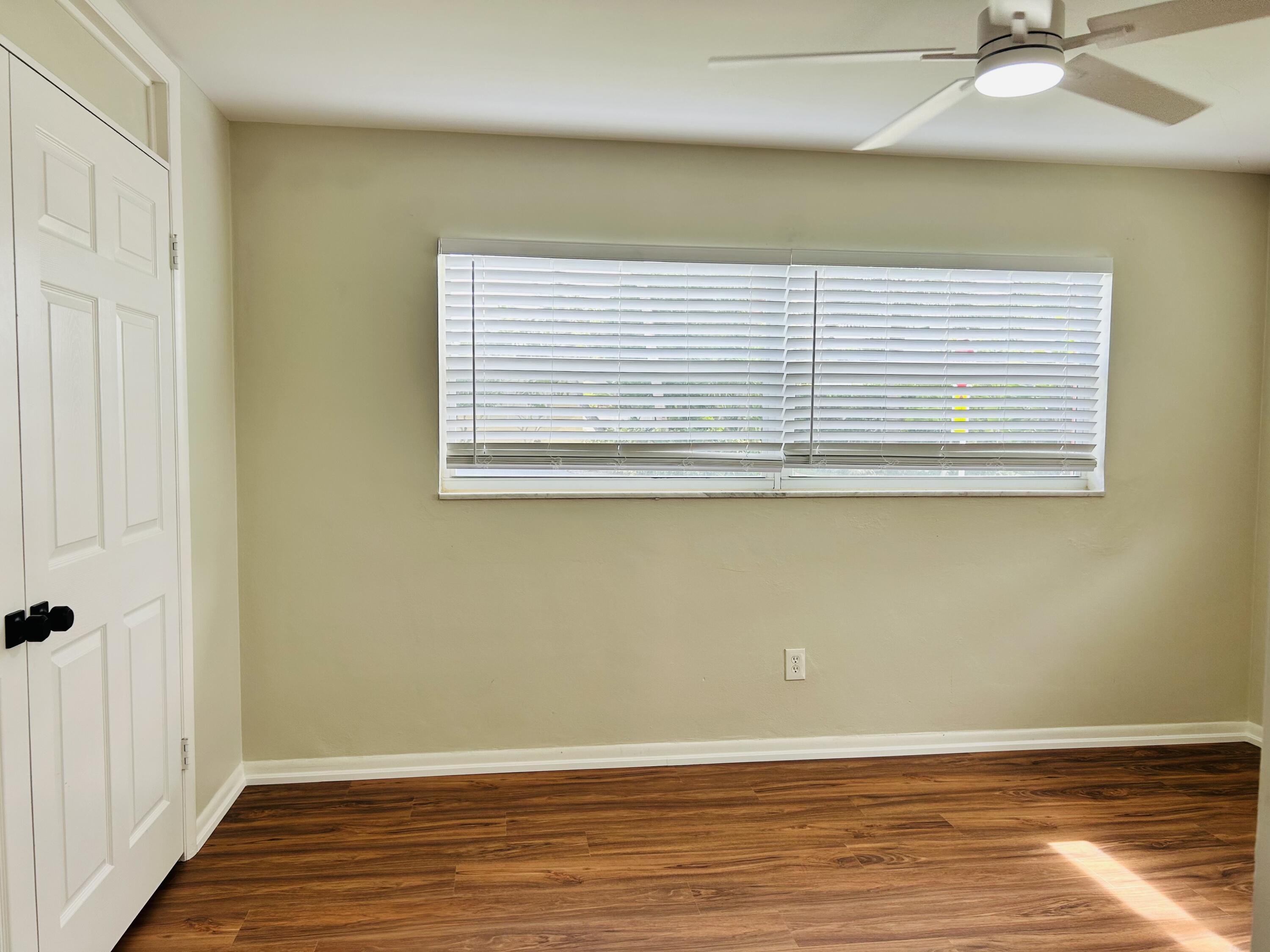 162 Beacon Lane Jupiter Inlet Colony, FL 33469 - Photo 9 of 16 a view of a room with wooden floor and a window