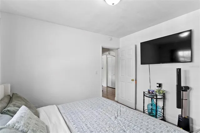 a bedroom with a bed and a flat screen tv