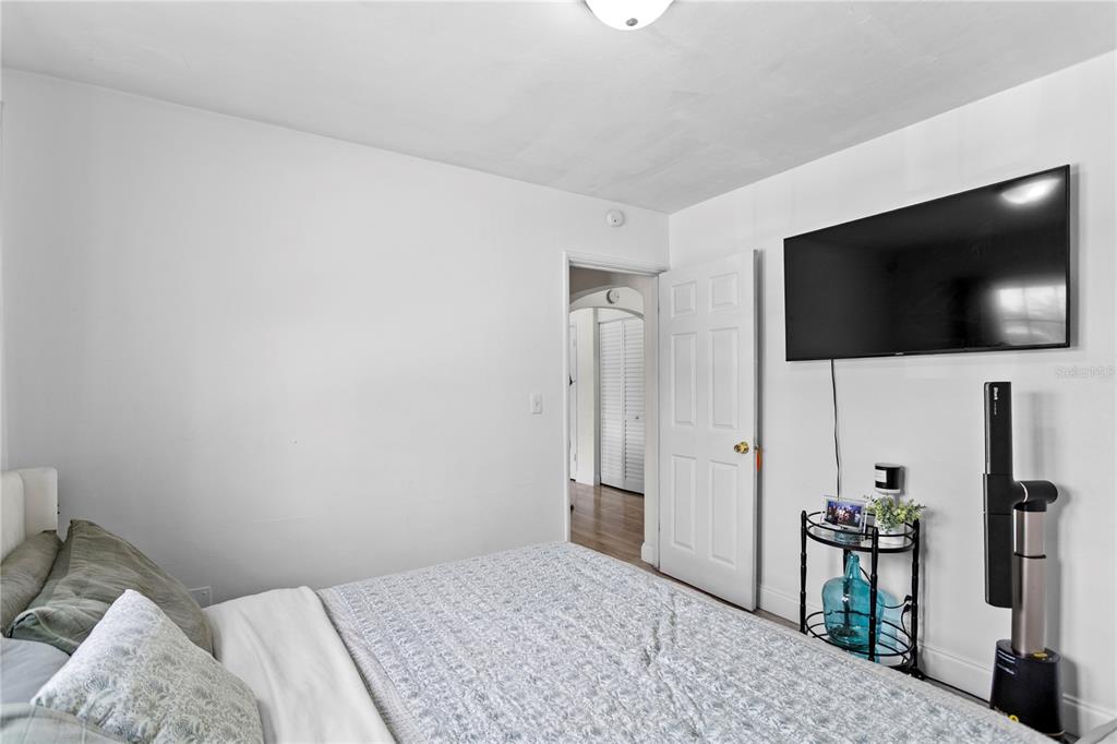 4762 Haines Road North St. Petersburg, FL 33714 - Photo 12 of 29 a bedroom with a bed and a flat screen tv