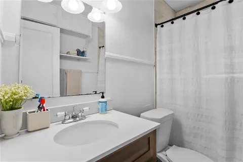 a bathroom with a sink toilet and shower