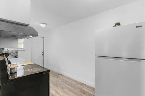 a room with a sink and a refrigerator