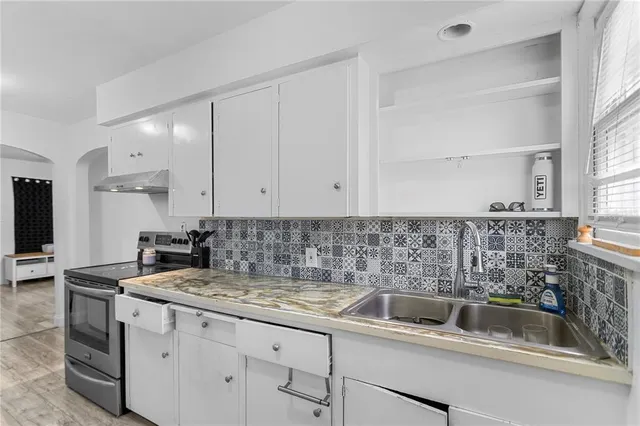 a kitchen with sink a cabinets and appliances