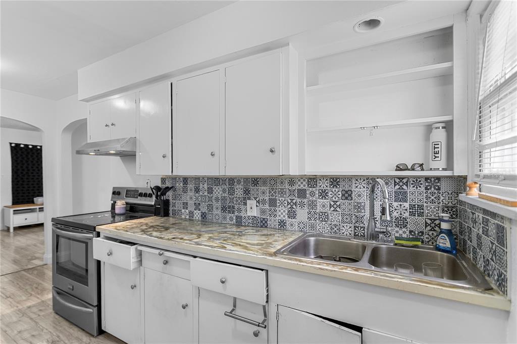 4762 Haines Road North St. Petersburg, FL 33714 - Photo 19 of 29 a kitchen with sink a cabinets and appliances