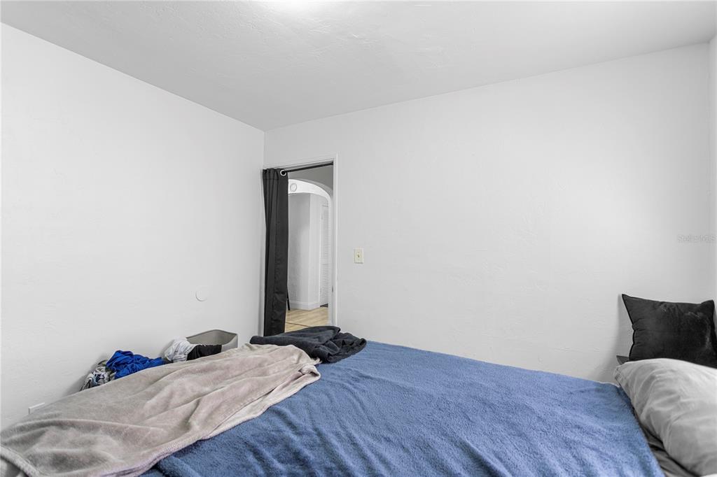 4762 Haines Road North St. Petersburg, FL 33714 - Photo 22 of 29 a bed sitting in a bedroom and wooden floor