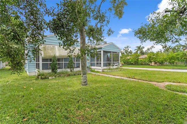 a view of a house with a backyard