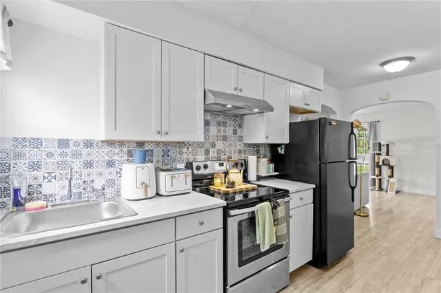 a kitchen with stainless steel appliances a refrigerator stove and sink