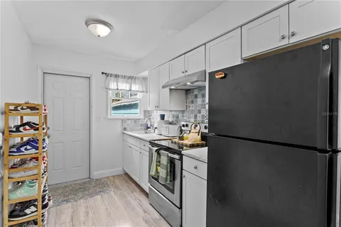 a kitchen with stainless steel appliances a refrigerator and a stove top oven