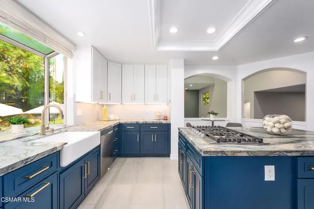 a living room with furniture a flat screen tv and a large window