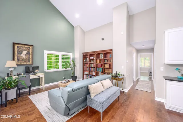 a bedroom with a bed and a painting on the wall