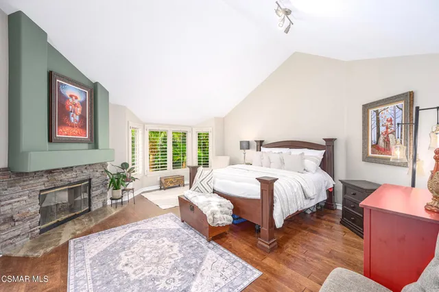 a bedroom with a bed and a fireplace