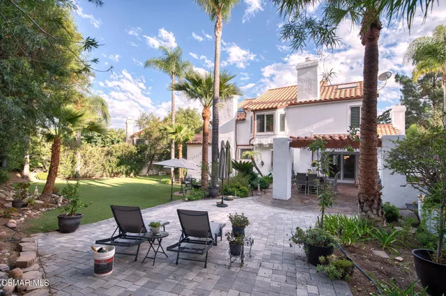 a view of a dining room with furniture and a potted plant
