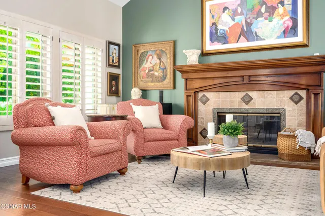 a living room with furniture a rug and a fireplace