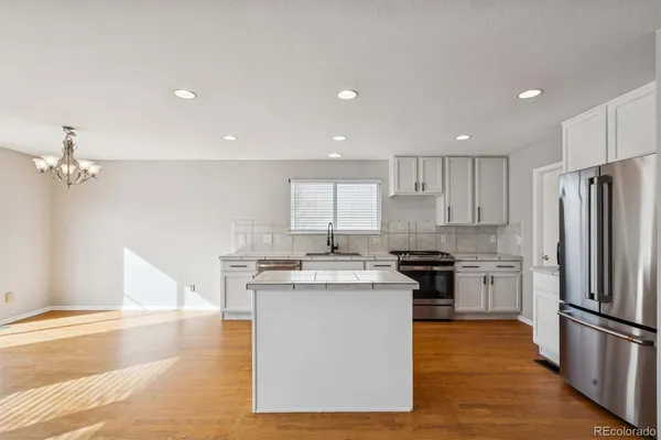 a kitchen with a stove a refrigerator and a sink