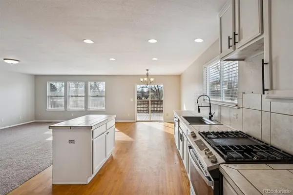 a kitchen with granite countertop a stove and a sink