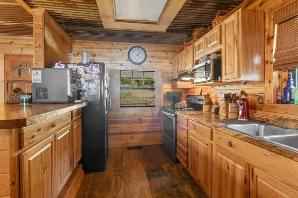 a kitchen with stainless steel appliances granite countertop a stove and cabinets