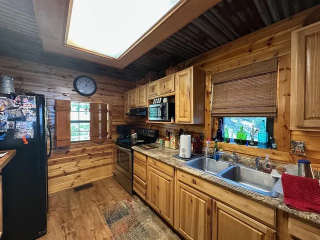 a kitchen with stainless steel appliances granite countertop a sink and cabinets