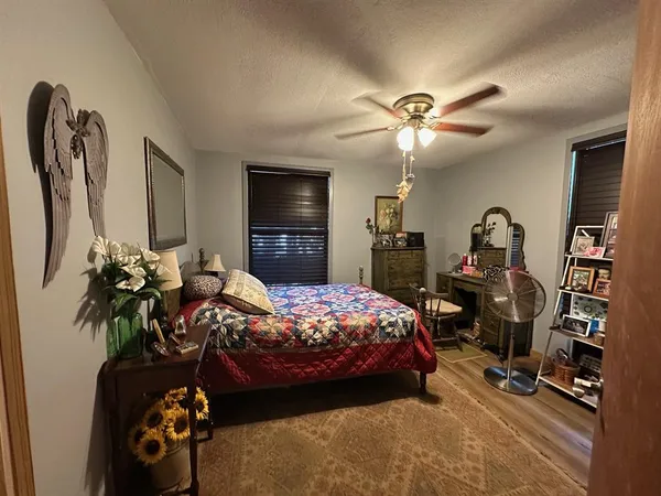 a bedroom with bed and a chandelier