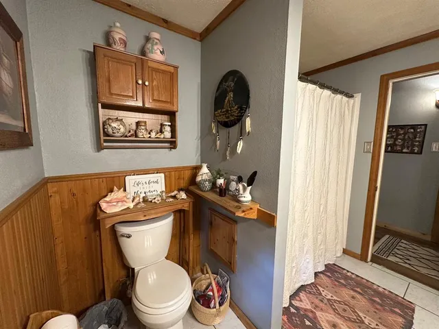 a white toilet sitting next to a bathroom sink