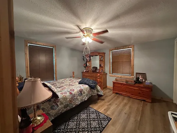 a bedroom with bed and a chandelier