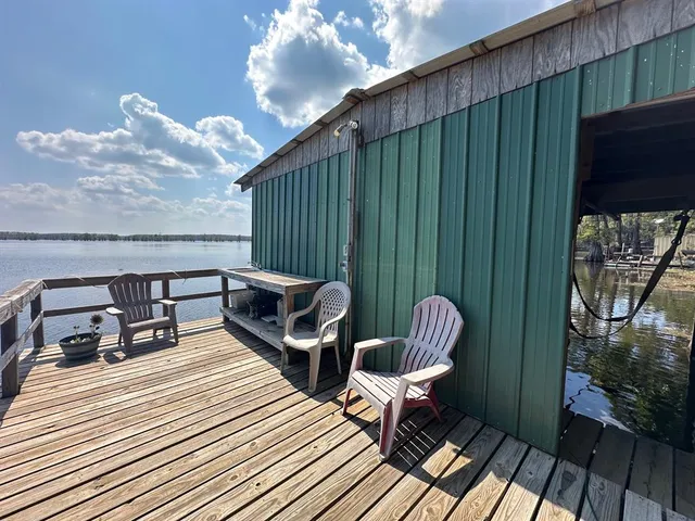 a balcony with hardwood filled with furniture and wooden floor