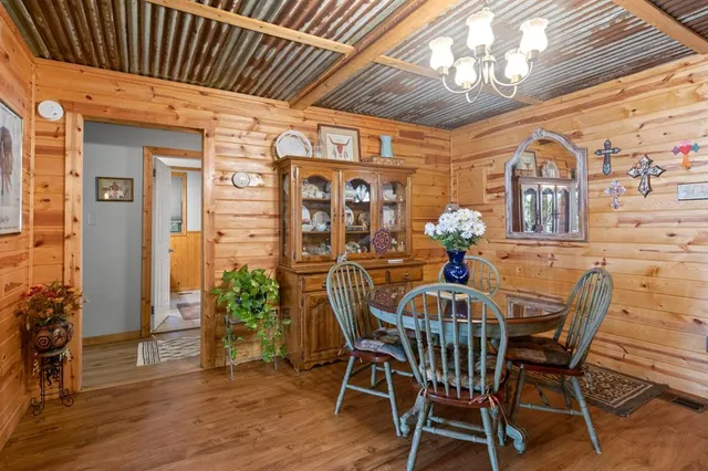 a view of a dining room with furniture wooden floor and a chandelier