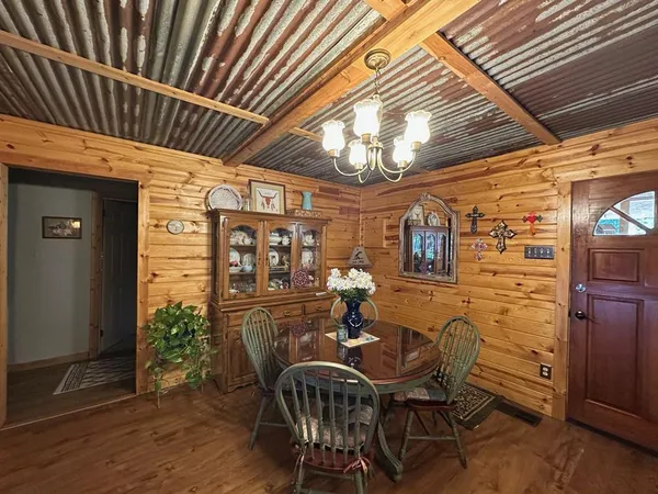 a view of a dining room with furniture and chandelier