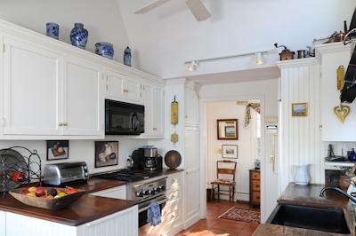 138 Stage Island Road Chatham, MA 02633 - Photo 5 of 19 a kitchen with stainless steel appliances a stove a sink a refrigerator and a cabinets
