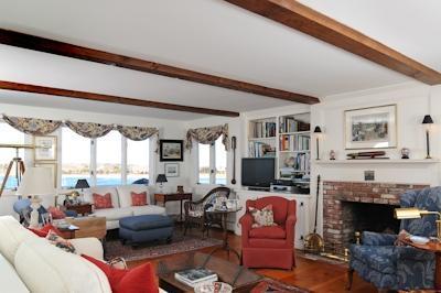 138 Stage Island Road Chatham, MA 02633 - Photo 9 of 19 a living room with furniture fireplace and a large window