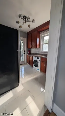a kitchen with granite countertop a sink stainless steel appliances and a window