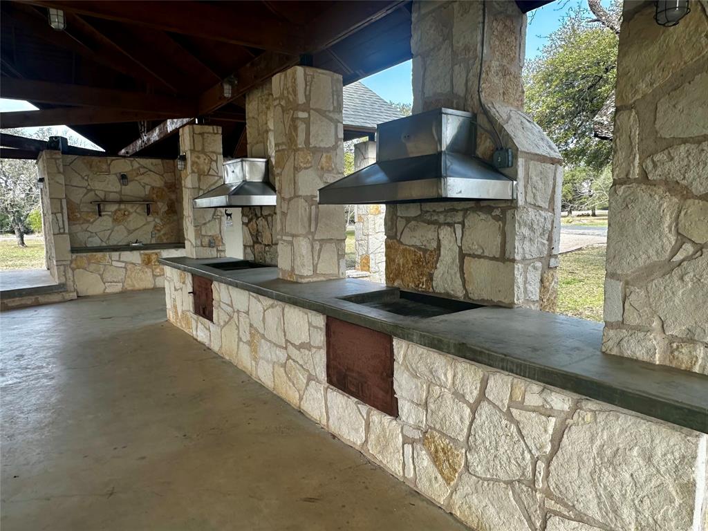 0 Eaton Lane Austin, TX 78724 - Photo 6 of 18 a kitchen with stainless steel appliances granite countertop a sink a stove and a wooden cabinets