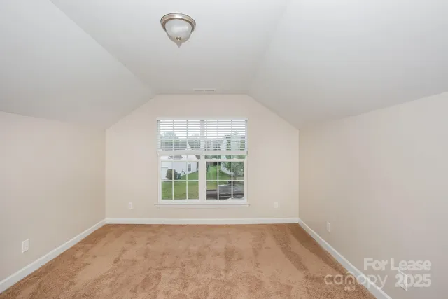 an empty room with a empty space and windows