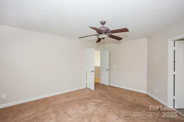 a view of a big room with a ceiling fan