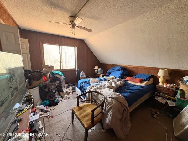 a bedroom with furniture and a window