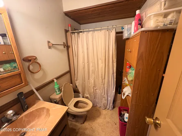 a bathroom with a toilet and shower