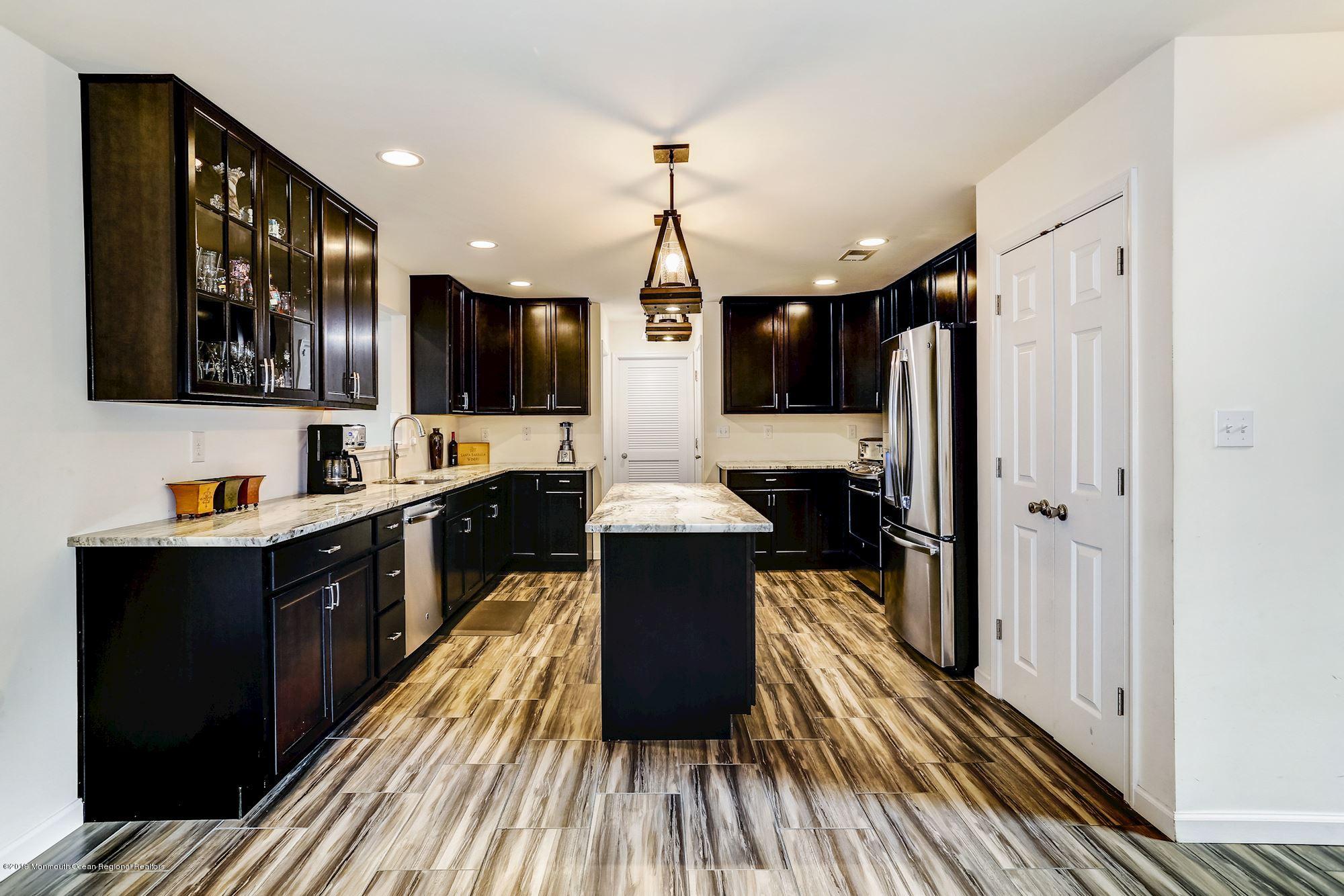 20 Pasadena Road Whiting, NJ 08759 - Photo 13 of 60 a kitchen with wooden floor a refrigerator and a sink