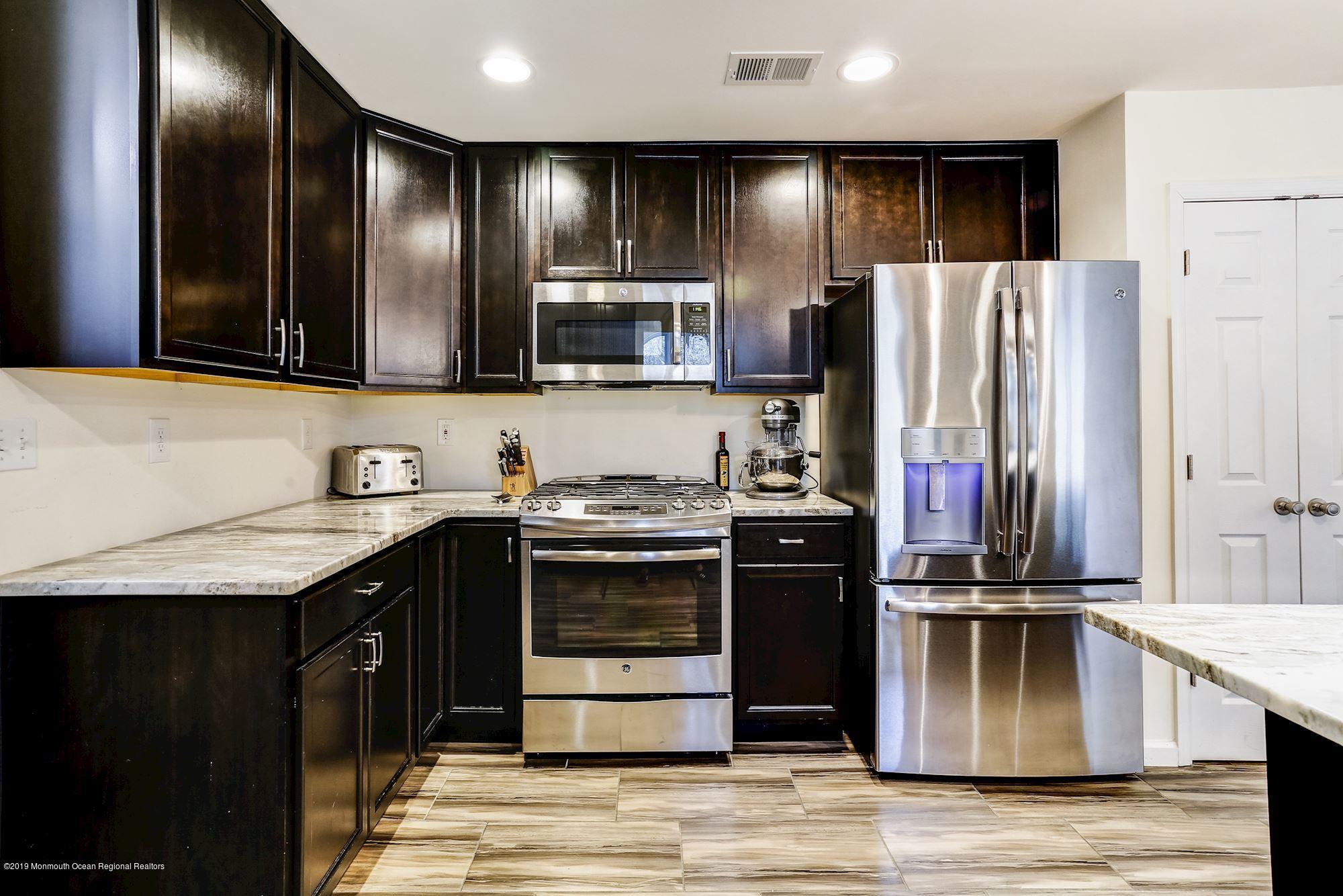 20 Pasadena Road Whiting, NJ 08759 - Photo 18 of 60 a kitchen with stainless steel appliances granite countertop a refrigerator and a stove