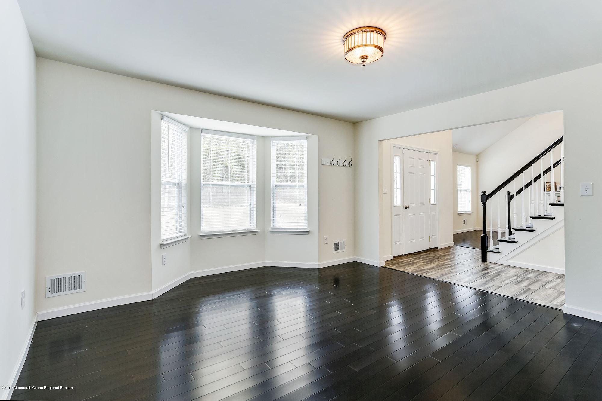 20 Pasadena Road Whiting, NJ 08759 - Photo 3 of 60 a view of an empty room with wooden floor and a window