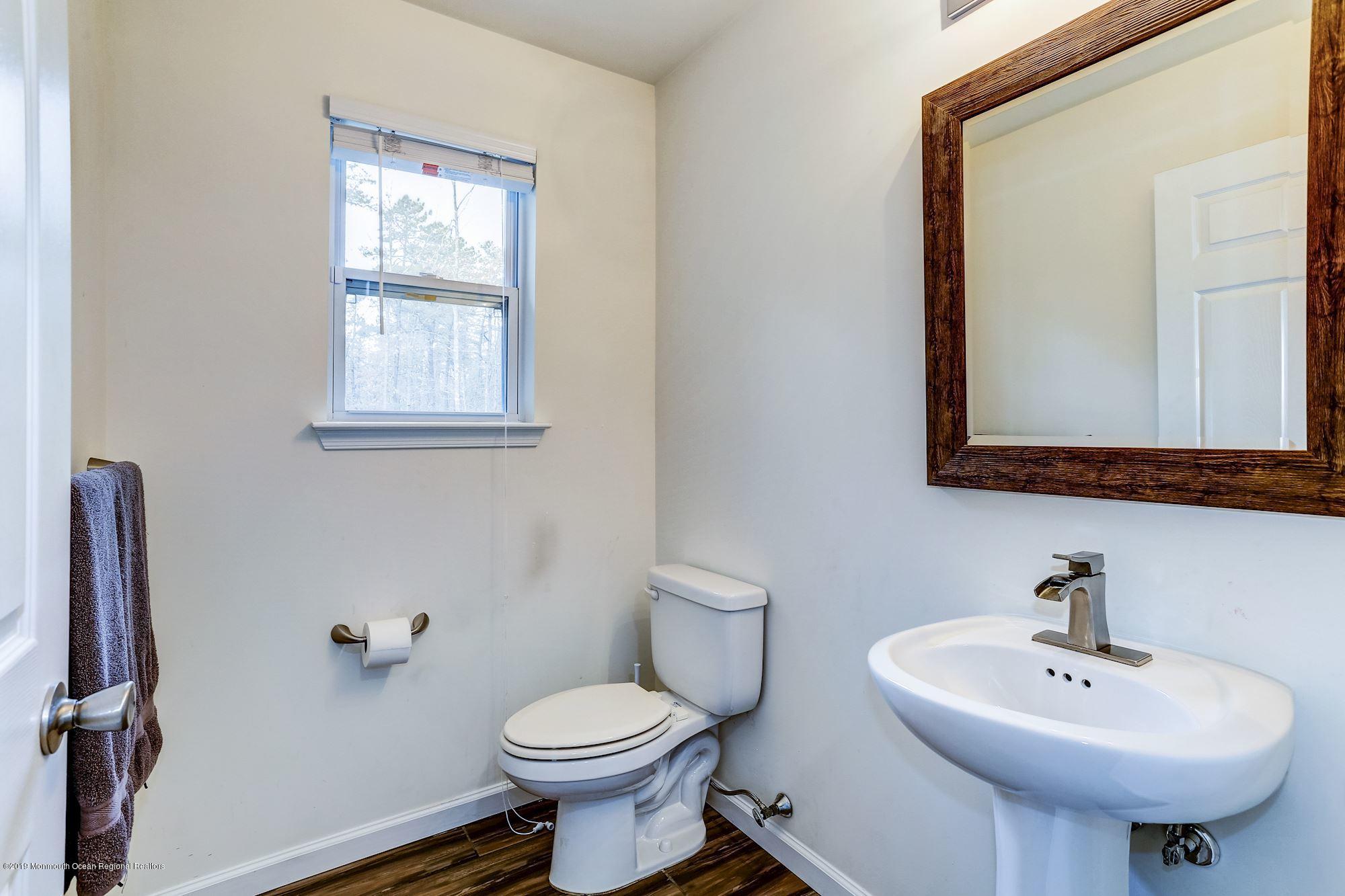 20 Pasadena Road Whiting, NJ 08759 - Photo 22 of 60 a bathroom with a sink a toilet and mirror