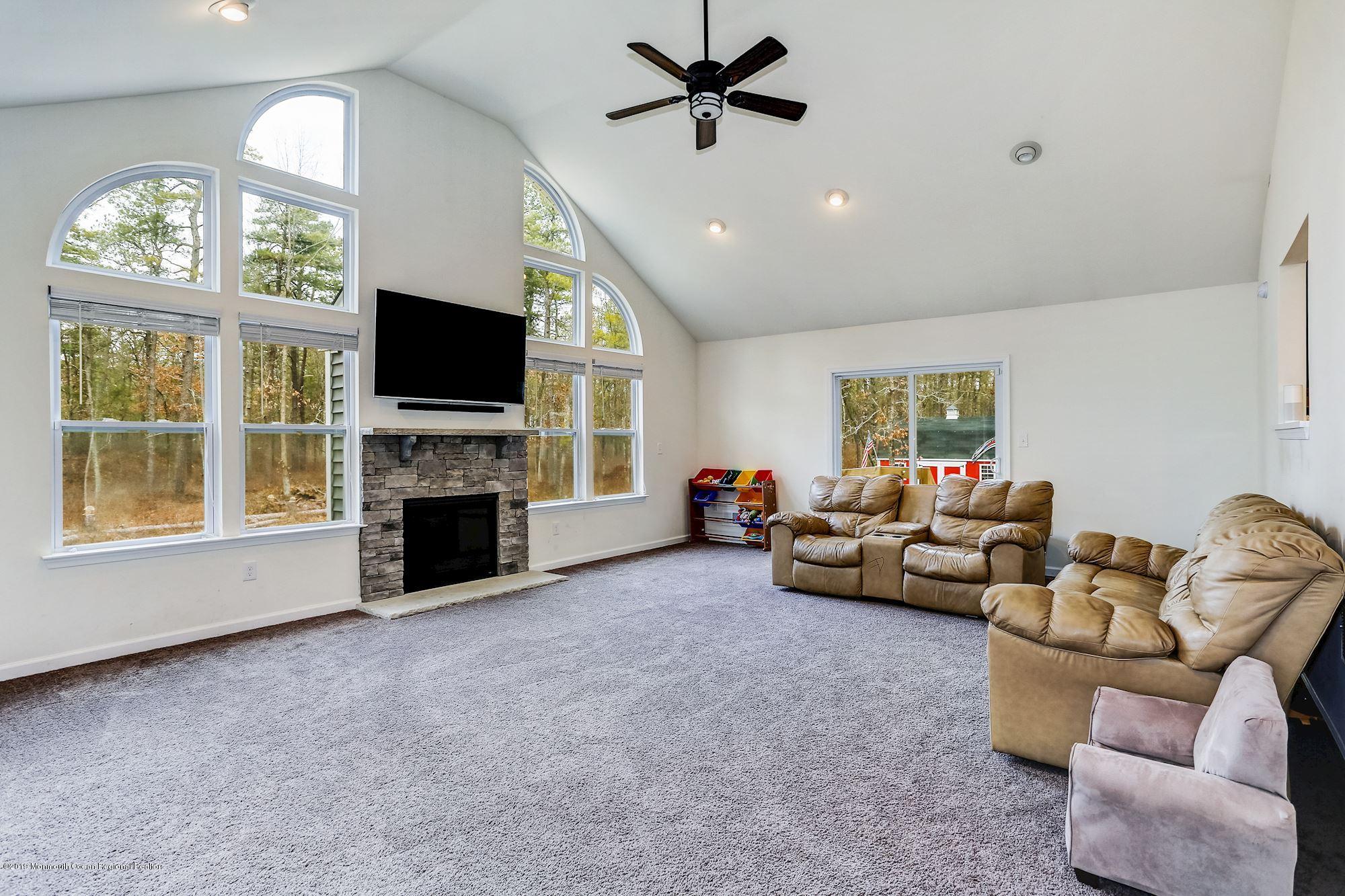 20 Pasadena Road Whiting, NJ 08759 - Photo 25 of 60 a living room with furniture a fireplace and a flat screen tv