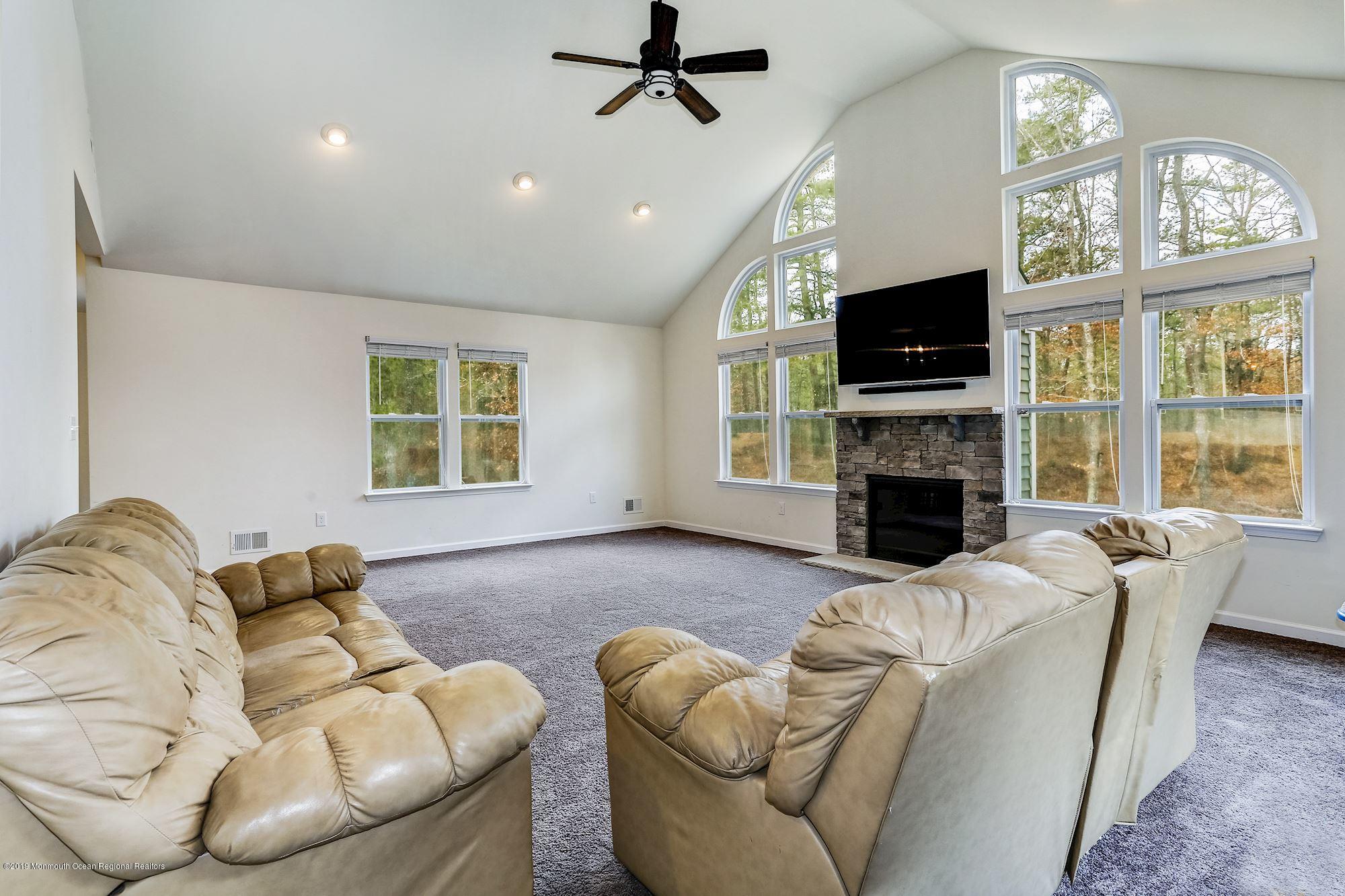 20 Pasadena Road Whiting, NJ 08759 - Photo 27 of 60 a living room with furniture a flat screen tv and a fireplace