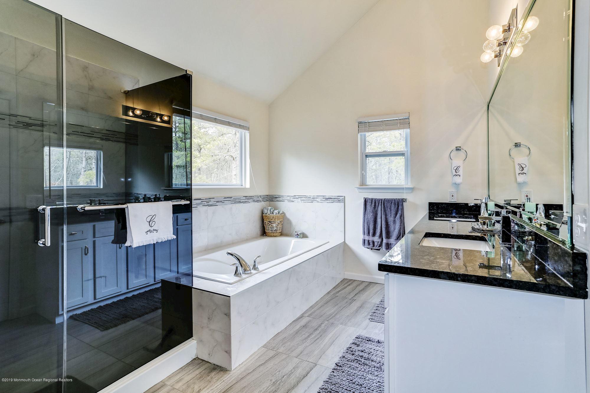 20 Pasadena Road Whiting, NJ 08759 - Photo 37 of 60 a en suite bathroom with a double vanity sink and a mirror
