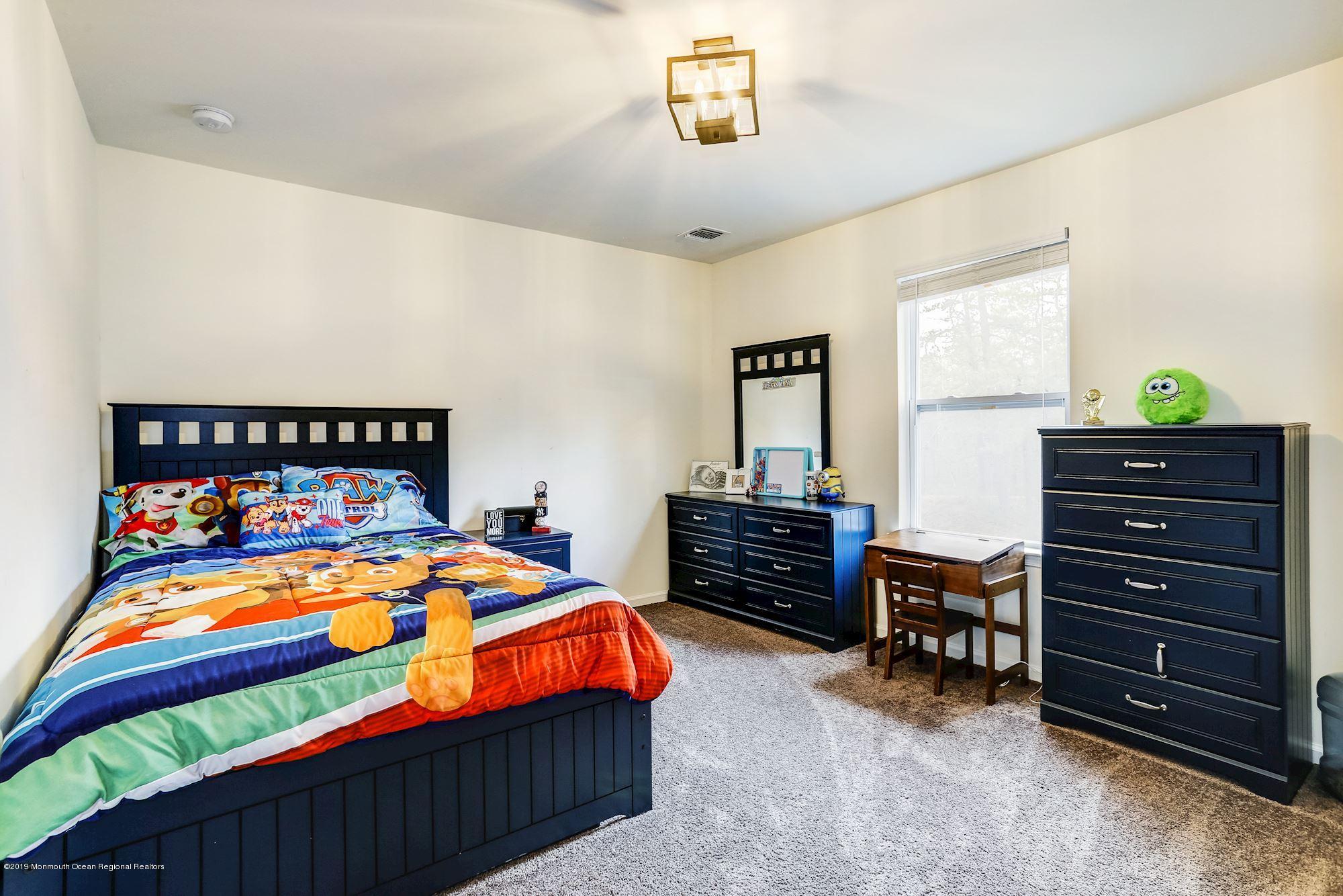 20 Pasadena Road Whiting, NJ 08759 - Photo 40 of 60 a bedroom with a bed and furniture