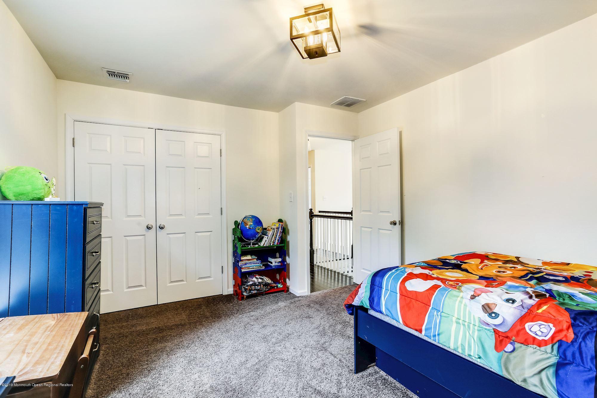 20 Pasadena Road Whiting, NJ 08759 - Photo 41 of 60 a bedroom with a bed and a chandelier