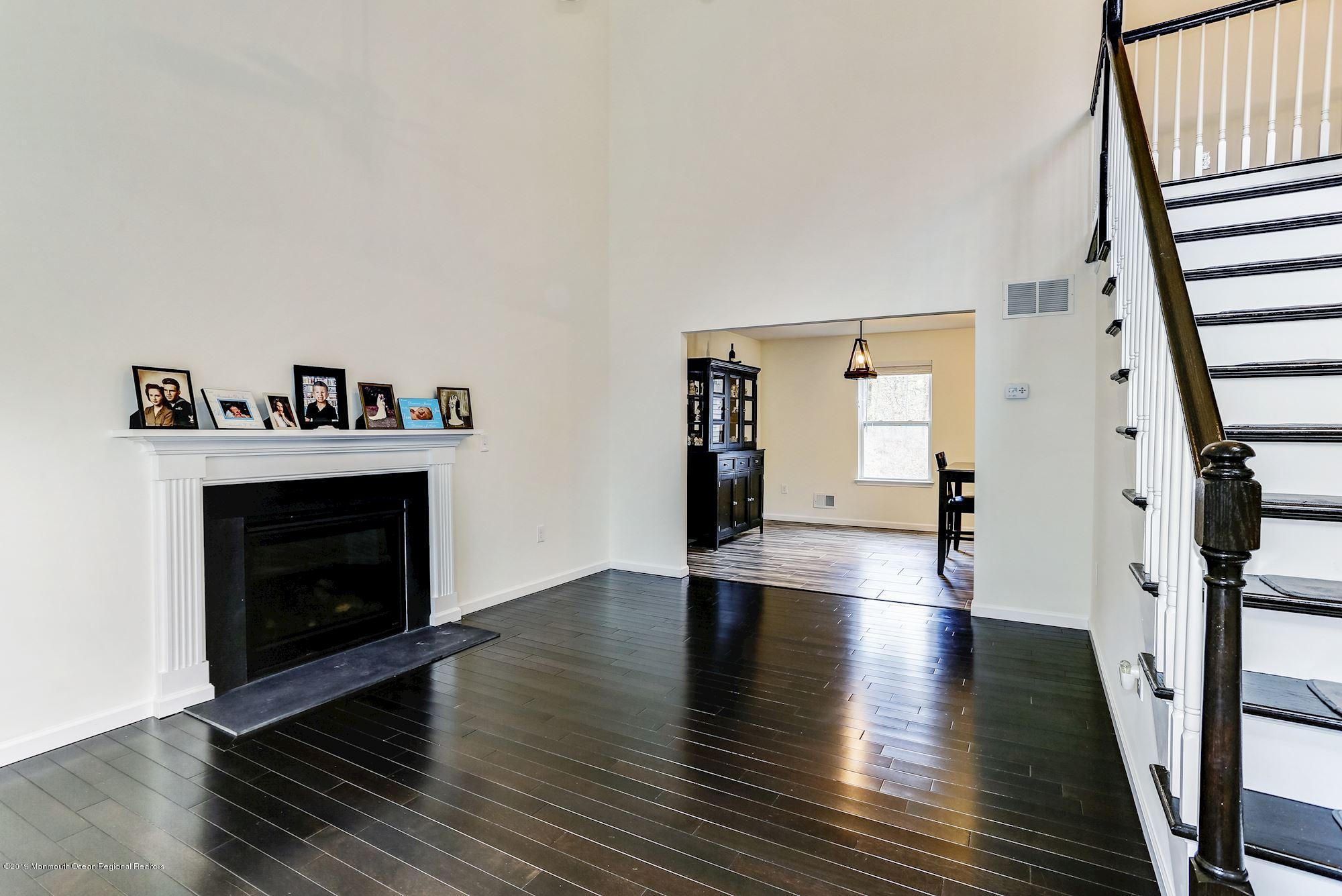 20 Pasadena Road Whiting, NJ 08759 - Photo 7 of 60 a view of an empty room with wooden floor and a fireplace