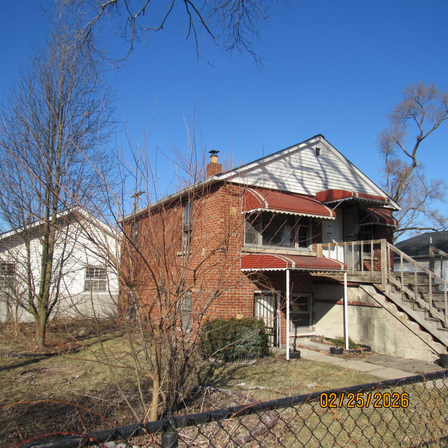 2468 Johnson Street Gary, IN 46407 - Photo 3 of 21 a roof deck with table and chairs under an umbrella