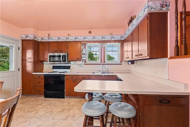 a kitchen with stainless steel appliances a sink and a stove