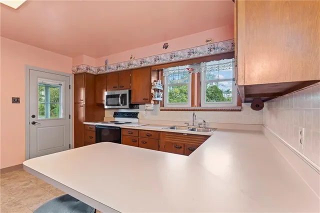 a kitchen with stainless steel appliances a sink and a stove