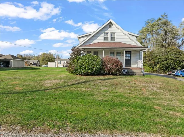 a front view of a house with a garden